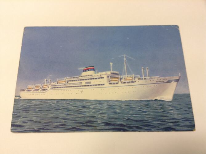 Postcard featuring photograph of ship at sea.