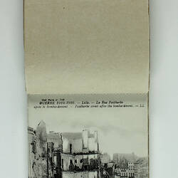 Inside page of postcard album with black and white photo.