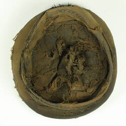 Underside view of old battered nightsoil collector's khaki flat top cap
