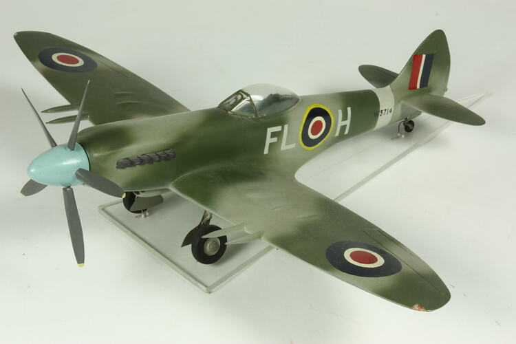 Model aeroplane with front propeller. Painted khaki camouflage.