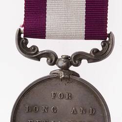 Medal with lettering suspended from bugundy and white ribbon.