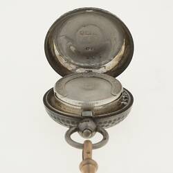 Detail of silver watch chain with silver sovereign case. Open.