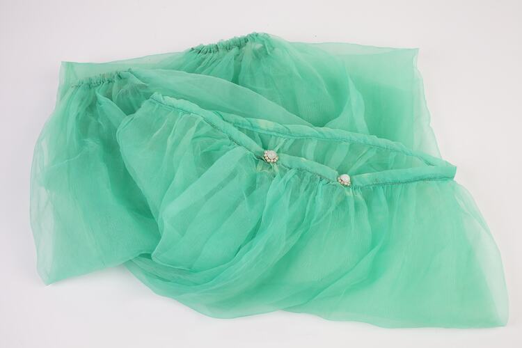 Green chiffon harem pants, elasticised at ankles. Two pearl buttons on waistband. Folded.