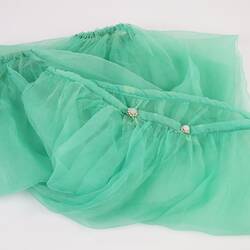 Green chiffon harem pants, elasticised at ankles. Two pearl buttons on waistband. Folded.