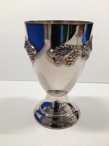 Silver goblet featuring grapevine design.