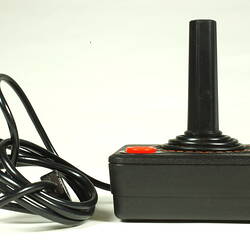 Side elevation of black plastic joystick showing power cable.