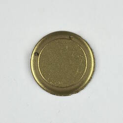 Back of toy round gold plate.