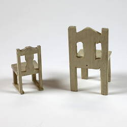 Reverse of small and large toy chairs.