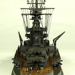 Naval ship with mast, rear view.