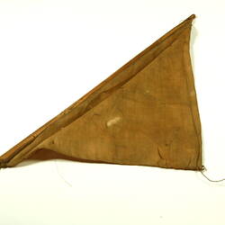 Brown triangular cloth with wooden rod.