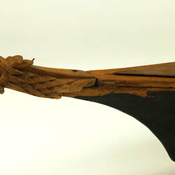 Wooden boat with black hull, front detail.