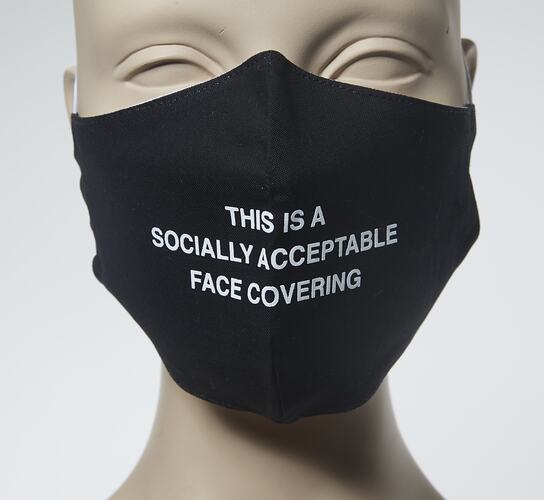 Black face mask with white lettering.