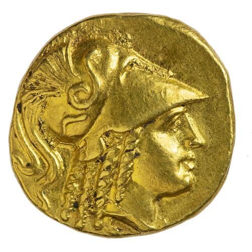 Head of Goddess Athena facing right wearing crested Corinthian helmet.