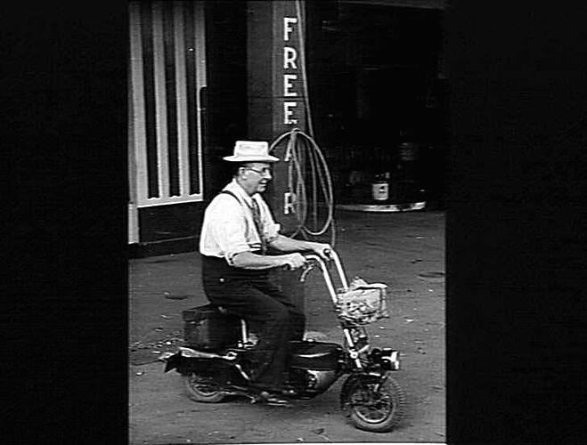 DUNE CAMERON TRIES OUT A MOTOR SCOOTER AT THE HORSHAM AGENCY. NOTE THE FOOD PARCEL AT FRONT AND THE TOOL CASE UNDER THE SEAT: `SUNSHINE REVIEW': MAR 1949