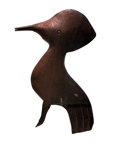 Simple unpainted wooden bird toy.
