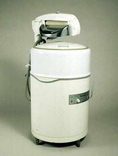 White washing machine with wringer on top.