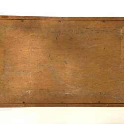 Plain underside of carved wooden tray.