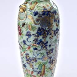 Porcelain vase with all-over pattern of birds, flowers, butterflies and two rats climbing amongst branches.