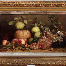 Fruit still life including grapes, quinces and a pumpkin.