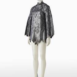 Short shift-style dress made from irregular pieces of pewter grey leather to resemble reptilian scales.