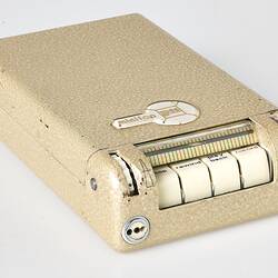 Rectangular cream metal case with four white labelled buttons at one end.