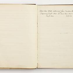 Open book with off white ruled pages. Handwritten text on right page.