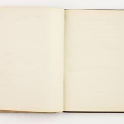 Open book with off white ruled pages.