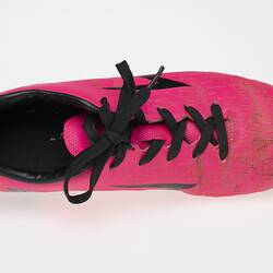 Pink Australian Rules football boot with black bootlace, inner sole and sole.