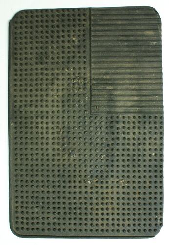 Rubber rectangular traction pad.