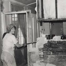Digital Photograph - Woman Demolishing Interior Wall in Kitchen, Fitzroy, 1976