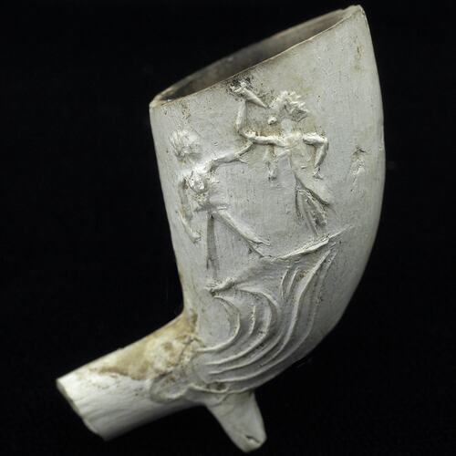 White pipe bowl with scene of two figures.