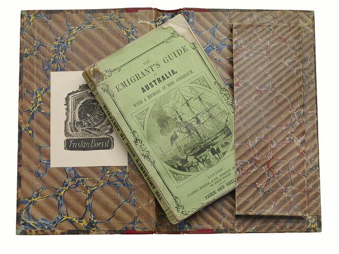Green book on open brown marbled case.
