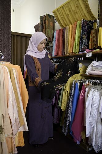 Woman looking at clothing in a clothing store.