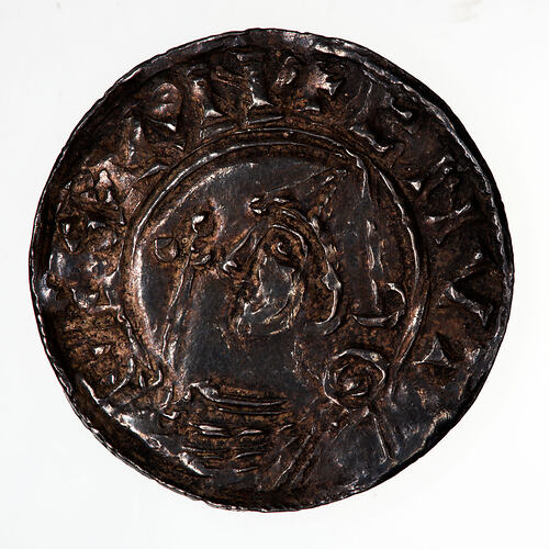 Coin, round, bust wearing pointed helmet facing left, in front, sceptre; text around, CNVT REX AN.