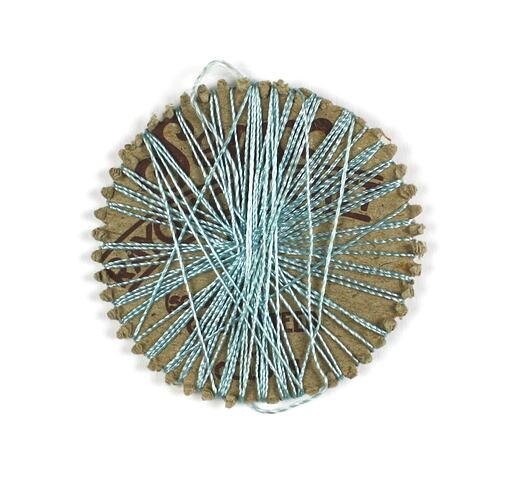 Round card of blue rayon thread.