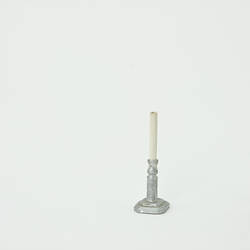 Silver candlestick with white candle