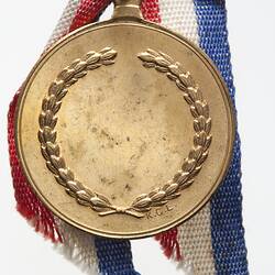 Medal with wreath border. Red, white blue ribbon.