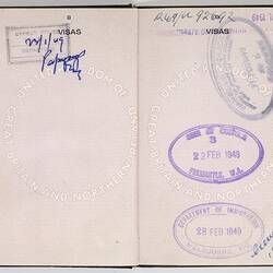 Open passport with white pages and black printing. Some handwriting. Stamped.