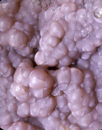 Detail of surface of pink bubble-like mineral.