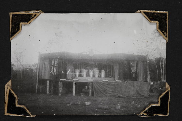 Outdoor stage with trees behind.