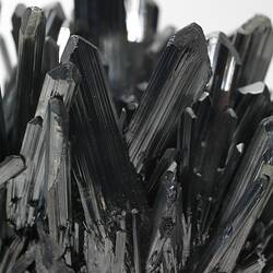 Black needle-like crystals.