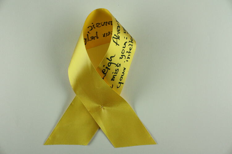 Yellow ribbon with black text.