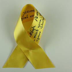 Yellow ribbon with black text.