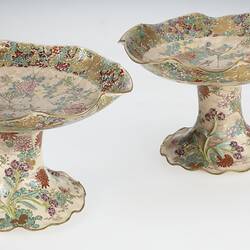 Pair of cream coloured compote with wavy edges decorated with birds & chrysanthemums.