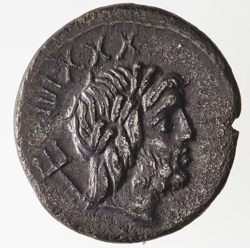Round coin, aged, male profile, facing right, wearing headdress, with trident over shoulder.