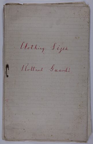 Front cover of booklet. Lined foolscap pages with rusted safety pin at left centre edge. Red handwritten text.