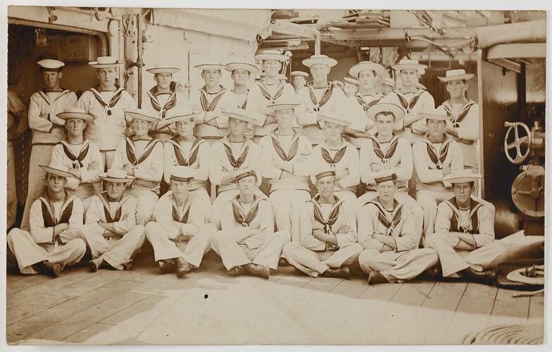 Group portrait of seamen on a ship deck.