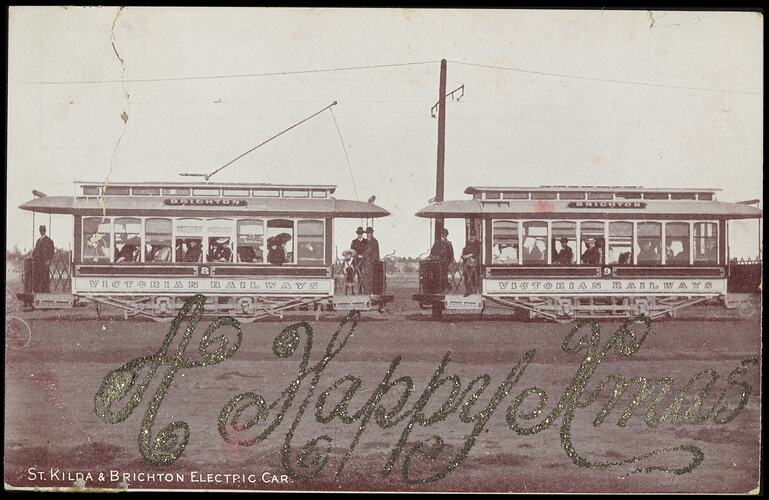 Two electric trams with people on board.