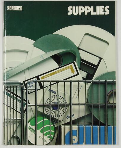 Black catalogue cover with colour photo of computer supplies in metal cage. Green and white text above.