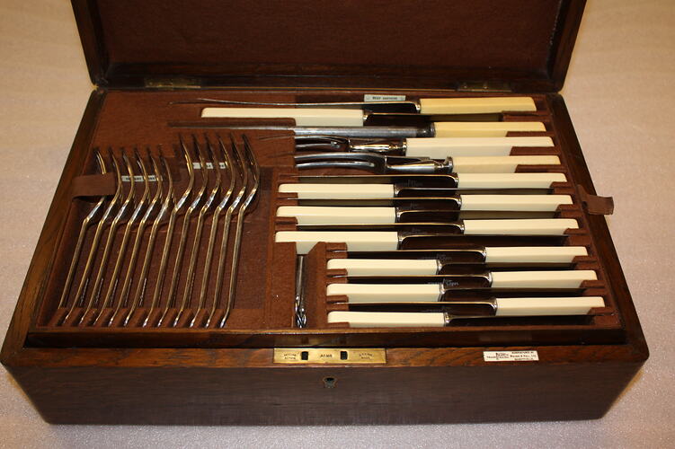 Open wooden cutlery box.